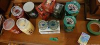 Top view showing assorted pillar and jar candles along with two glass holders and Pine Wonderland candles