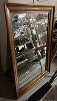 Full view of the vintage rectangular mirror with solid wood frame showing its size and condition.