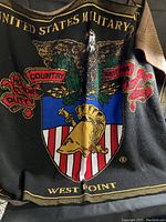 Close detail of the eagle emblem with text Duty, Honor, Country, West Point, United States Military on black background