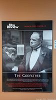 Full view of The Godfather black and white board poster with Marlon Brando character on it.