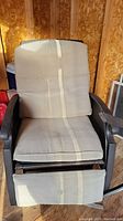 Front view of outdoor recliner chair showing padded cushions and footrest extended.