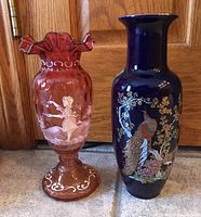 Photo showing both vases side by side against wood background, with details of cranberry glass vase on left and blue Japanese style vase on right.