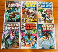 Full front cover view of six Iron Man comics in protective sleeves, showing vibrant artwork.
