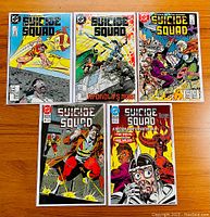 Front view of five Suicide Squad comic books from the 1987 DC series, issues 32, 33, 34, 51, and 52, showing colorful covers depicting various characters and action scenes.