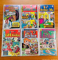 Photo of six vintage Archie comic books displayed in two rows of three, showing front covers that feature colorful illustrations typical of Archie comics.