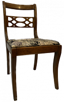 Antique mahogany side chair with hand-carved decorative backrest and reupholstered cushioned seat, angled view showing chair craftsmanship and condition.