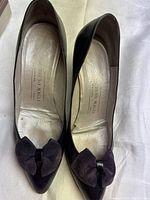 Top-down view of the pair of soft purple leather Bruno Magli shoes, showing pointed toe and bow detail on each shoe.
