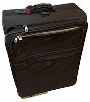 Front and side view of large black soft suitcase showing wear and multiple zippered compartments.