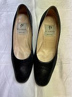 Top down view showing the pair of black textured leather shoes, interior labels indicating Di Sandro brand and Made in Italy origin.