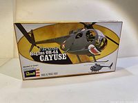 Closed box showing vintage Revell 1/32 scale Hughes OH-6A Cayuse helicopter model kit with detailed artwork.