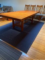 Full view of extended table showing two leaves and slatted leg base