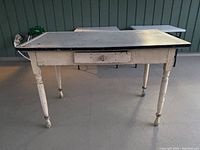 Full view of the farm table showing wooden structure, drawer, and metal top.