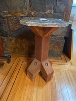 Full view of wooden base and stone top showing overall design and proportions.