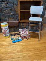 Overview photo showing all items in the lot: stool, umbrella stand, sewing basket, records, and wooden shelf.