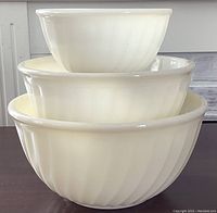 Photo showing all three white milk glass swirl mixing bowls nested together, sizes 6, 8, and 9.