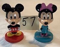 Front view of Mickey and Minnie Mouse bobbleheads showing condition and size
