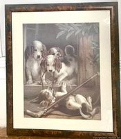 Full view of the framed print showing four puppies, frame with minor scratches, and matting.