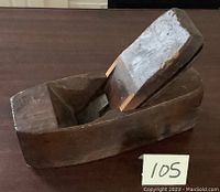 Angled view of wooden plane body with installed wedge