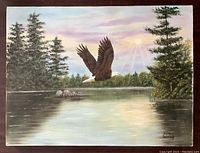 Front view of original painting showing the eagle in flight over a river with surrounding trees and sky, signed by Irene Kennedy.
