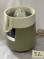 Side view of assembled vintage Van Wyck electric citrus juicer in avocado green with label and power cord visible
