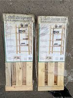 Photo of packaged 5-shelf storage units showing label with assembly instructions and product details.