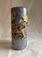 Full view of umbrella stand displaying the floral and bird artwork on gray marbled surface.