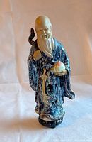 Front view of the Chinese Shiwan Mudman pottery figurine showing detailed facial expression and peach in hand.