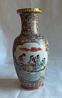 Front view of the vase showing hand-painted figures on boat, red clouds overhead, and detailed floral patterns around the body.
