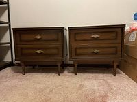 Pair of nightstands front view showing drawer fronts, handles and overall shape
