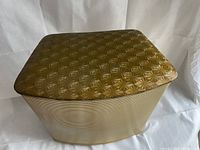 Top view of the hamper lid showing raised starburst pattern.