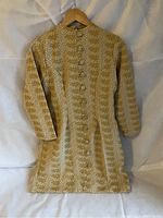 Gold and white woven patterned long garment hung on wooden hanger, front view