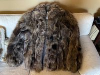 Full front view of coat laid flat on sofa