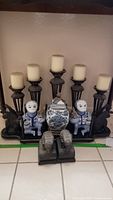 Full set including five black candle holders with white candles, two blue and white ceramic monkey ginger jars with brass accents, and two grey heavy elephant bookends with detailed carvings.