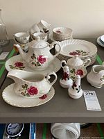 Full set of Ridgeway Ironstone Anniversary Rose china including plates, cups, saucers, serving pieces arranged on a table