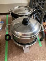 Large pots stacked and arranged showing lids, handles, and sizes