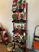 Full view of the wooden display shelf showing multiple tiers with Christmas nutcracker figurines on it (items not included).