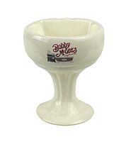 Front side view of the off-white pedestal mug with Bobby McGee's logo in red and black ink on the front.