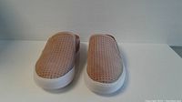 Front view of new pair of beige perforated Franco Sarto Carona slip-on mule shoes with white soles.