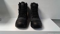 Front view of black and gray men's hiking boots with laces and padded collars.