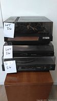 Three stacked vintage turntables with visible brand labels and dust covers.