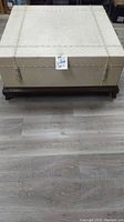 Top view of vintage square coffee table showing textured cream finish with decorative rope trim and tassels