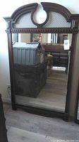 Full view of the large rectangular mirror with detailed wood frame, top decorative cutout and lattice design, showing overall condition and size.