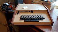 Front overview showing integrated keyboard and wood side panels
