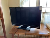 Sony KDL-40S54 Bravia TV on table, full front view showing screen and base stand with power cord attached.