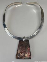 Full view of the sterling silver choker necklace with trapezoidal ammolite pendant showing the entire piece.