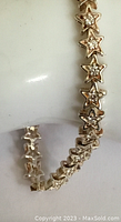 Close-up of the star-shaped links with embedded clear crystals on the sterling silver bracelet.
