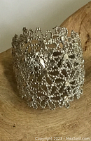 Close-up photo showing the detailed snowflake cutout design and textured surface of the sterling silver ring.