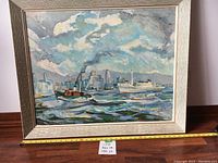 Framed vintage oil painting on board showing ships on water with a cityscape in background. Includes ruler for size reference.