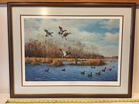 Full view of the framed lithograph showing a wetland scene with flying and swimming ducks, wood frame, and measured with tape, approximately 32" W x 25" H frame size.