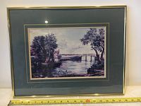 Framed lithograph artwork showing measuring tape at bottom indicating frame width approximately 18 inches.